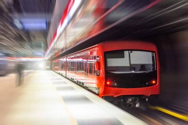 Passing underground train to the tunnel on the subway platform, motion blur.