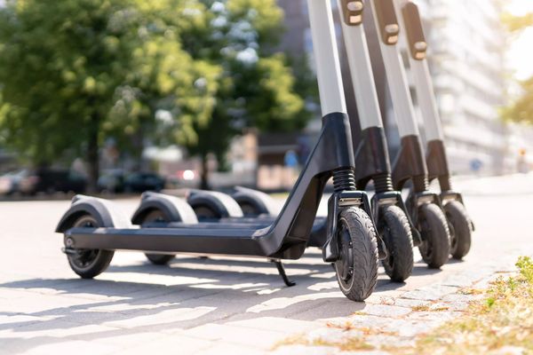 Electric kick scooters in city. E vehicle for rent. Urban modern transportation and technology concept.