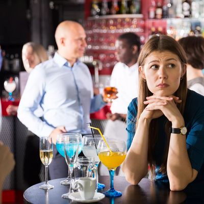Upset young woman at corporate bar party
