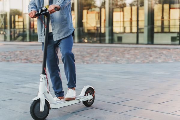 Man riding his e-scooter on the city street
